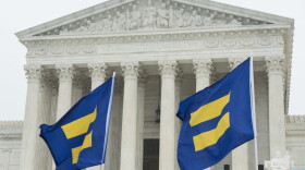 Supporters of LGBTQ equality fly Human Rights Campaign flags in front of the Supreme Court during oral arguments for Masterpiece Cakeshop case on Tuesday, Dec. 5, 2017, in Washington. (Kevin Wolf/AP Images for Human Rights Campaign)