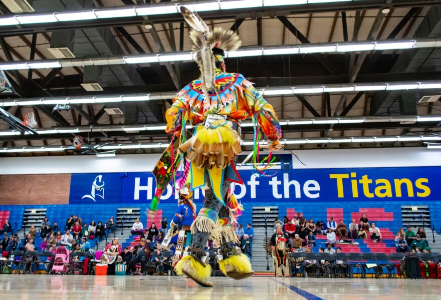 Pow-wow dancer in LCC gymnasium. 