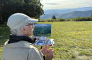 David Dorrell of New Jersey paints a landscape from Rocky Knob during the 2026 Floyd Plein Air Biennial.