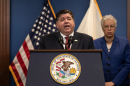 Governor J.B. Pritzker speaking at a podium with Cook County President Toni Preckwinkle standing behind him. Illinois Gov. JB Pritzker and Cook County Board President Toni Preckwinkle discussed legislation to forgive medical debt for Illinoisans in April 2024.