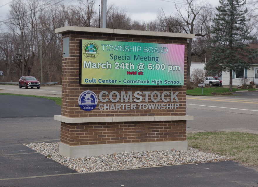A sign advertises Tuesday's special meeting of the Comstock Charter Township Board
