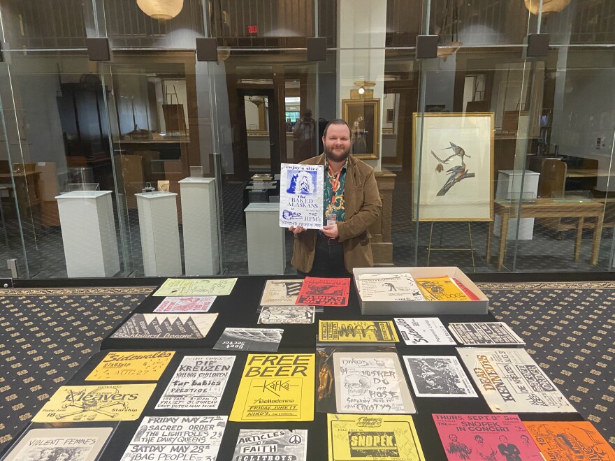 MPL Rare Books Librarian Timothy Rush shows of the library's poster collection.