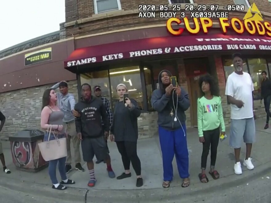 An image from a police body camera shows bystanders outside Cup Foods in Minneapolis on May 25, 2020, with Darnella Frazier third from right. The 10-minute video she filmed at the scene was seen by millions and played a pivotal role in the trial of Derek Chauvin, who was convicted of murder and manslaughter charges on Tuesday.
