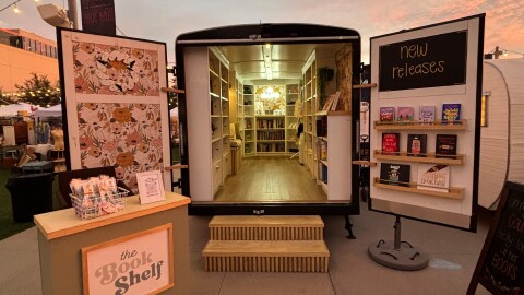 The book shelf mobile bookshop, with its trailer doors open and a table just outside