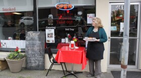 Betty Walker waits for shipyard workers to speed walk past her restaurant, the Sweet and Smokey Diner. The shift ends a few minutes from now at 4:02