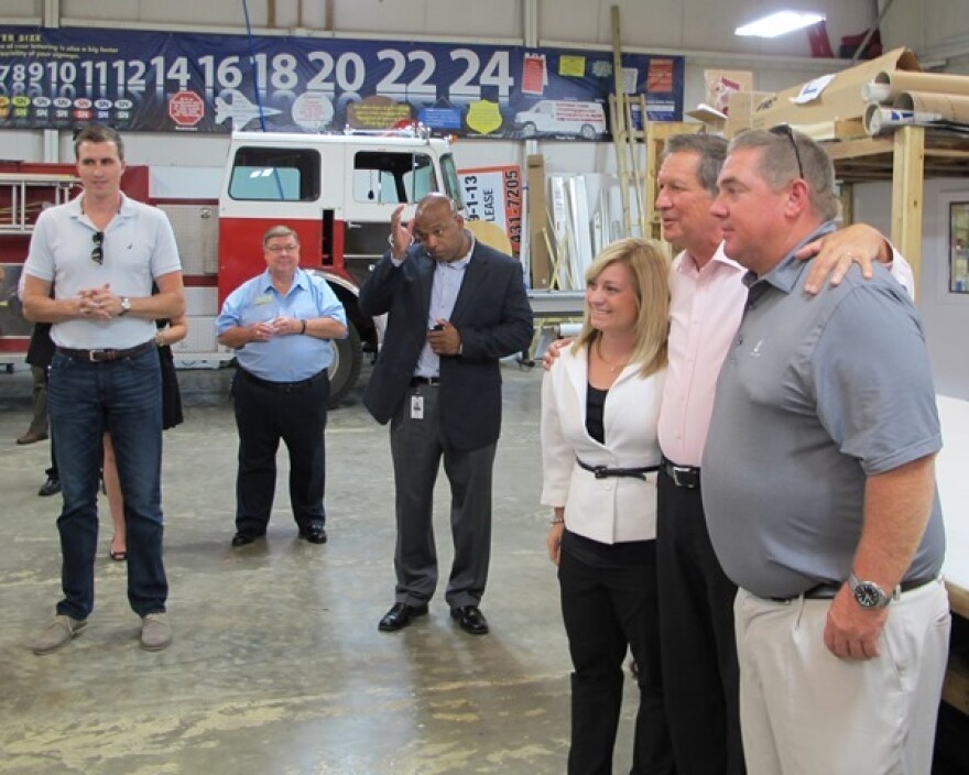 Gov. John Kasich poses for photos with supporters. (Karen Kasler / Ohio Public Radio)