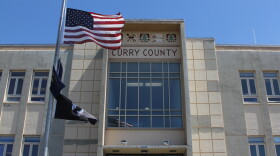 The Curry County Administrative Annex building, with American flag flying in front of the building and "Curry County" displayed above the entrance.
