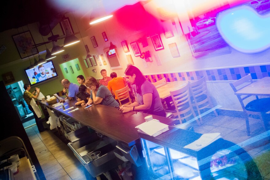 Patrons of Café Croissant enjoy a meal at one of the few restaurants open in Miami ahead of the arrival of Hurricane Irma on Saturday.