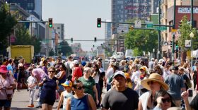A crowd of people walking in the downtown streets of Denver.