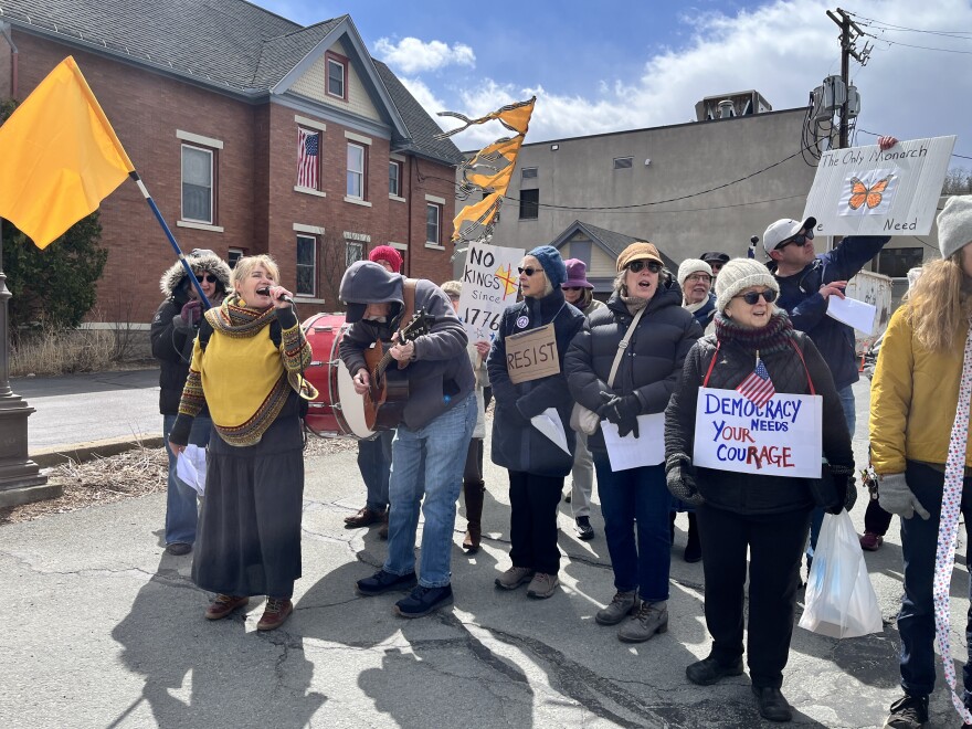 Tannis Kowalchuk, left with microphone, leads the Singing Resistance NEPA choir during a No Kings march in Honesdale.