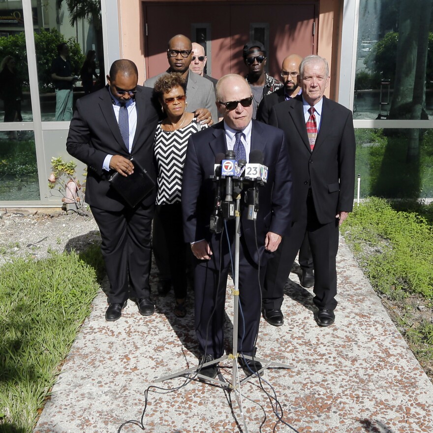 Attorney David Schoen, center, talks to reporters during a news conference in 2015 with the family of Jermaine McBean, who was shot and killed by a sheriff's deputy while carrying an air rifle, in Fort Lauderdale, Fla.