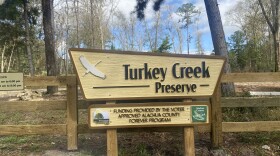 A sign marks the entrance to the Northwest 93rd Avenue trailhead and parking lot at Turkey Creek Preserve. (Kala Parkinson/WUFT News)