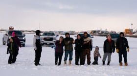 The crowd is filled with anticipation as Robert Charles Jr. approaches the finish line of the 2024 Bogus Creek 150, followed closely by Fr. Alexander Larson. Feb. 11 in Bethel, Alaska.