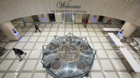 People walk inside the Florida Capitol during a legislative session in Tallahassee, Fla., Thursday, March 6, 2025.