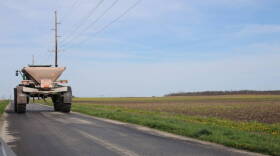 A farmer drives his equipment to a maintenance facility in Brookston on Monday ahead of spring planting.