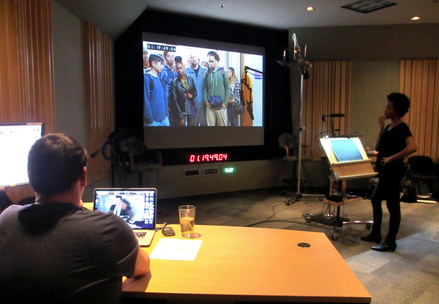 Supervising sound editor Rob Nokes (left) and looper Lanei Chapman watch a silent scene to get a sense of what to say during a looping session for the television show <em>Bones</em>.