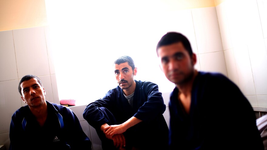 Saleh (from left), 25, Mohammed Ibrahim, 31, and Nisar Ahmed, 23, sit in a drug rehabilitation center on the outskirts of Herat. Opium grown in Afghanistan has long been smuggled through Herat on its way to Iran and to the West. Now Herat has many drug addicts of its own.