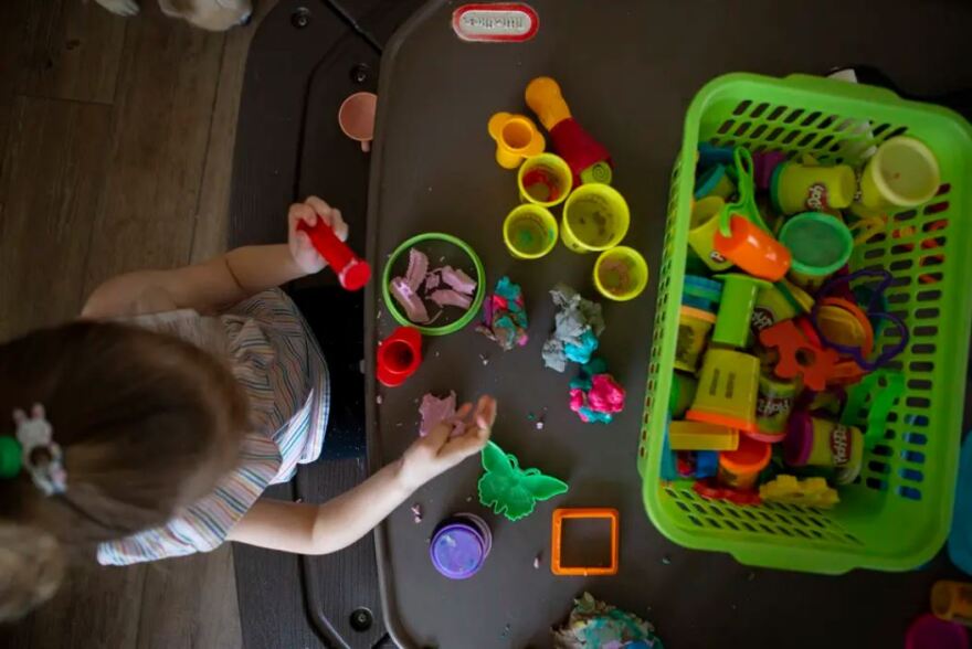  <br/><br/><br/><br/>A child plays with Play-Doh at Kid's Castle Family Daycare and Preschool in Pflugerville, on Feb. 28, 2022. 