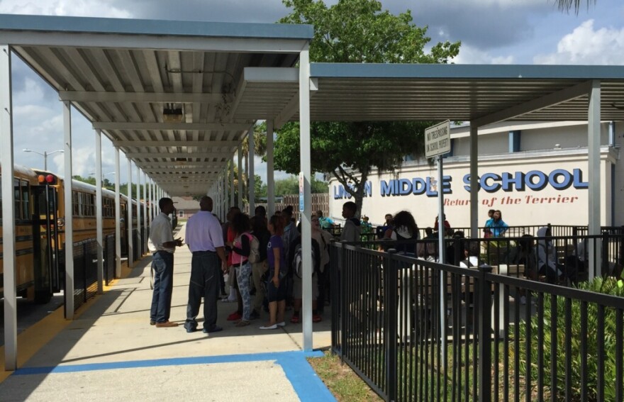 Students at Lincoln Middle School gather outside after the school received a bomb threat. The call came in around 1:30 p.m. on Friday.