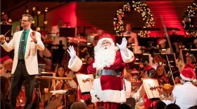 At the Kansas City Symphony's Christmas Fest, Santa often makes an early appearance as pictured here with Associate Conductor Jason Seber (at left).