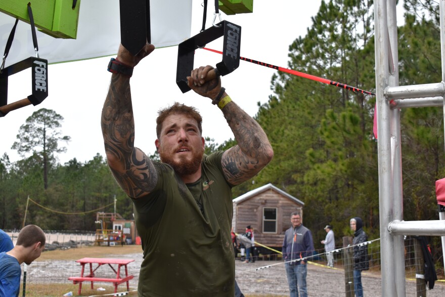 Competitor Travis Pierce tackles the steel rig part of the course on Saturday in Waldo. (Reagan Knight/WUFT News)