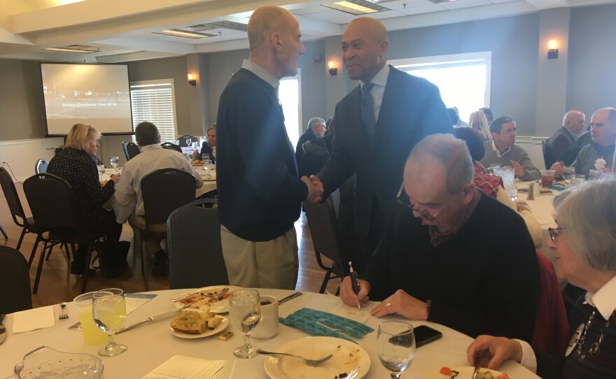 Former Massachusetts Governor Deval Patrick greets members of the audience before speaking to the Portsmouth Rotary Club.