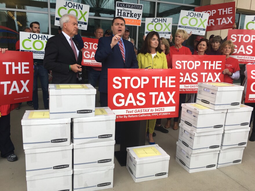 Republican gubernatorial candidate John Cox (left) and organizer Carl DeMaio (center) lead a petition drive last month to repeal California's gas taxes and vehicle registration fees.