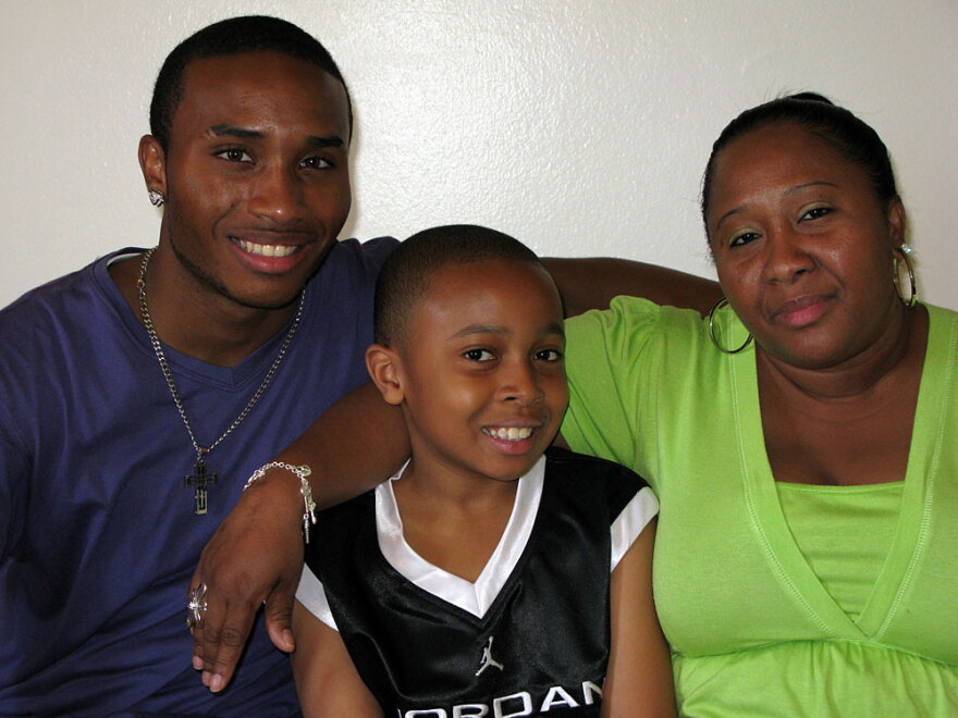 Terrence, Tyrone and Sharon Flowers at their home in Brooklyn. The family is taking part in a city experiment that pays poor families for engaging in positive behaviors.