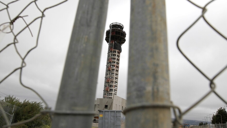 A fence secures the perimeter of a half-completed 236-foot FAA control tower at Oakland International Airport. Construction has been halted because of the FAA shutdown.