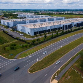 FILE - Cars drive past data centers that house computer servers and hardware required to support modern internet use, such as artificial intelligence, in Ashburn, Virginia, July 16, 2023.
