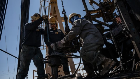 A service rig crew pulls sucker rods from an oil and gas well as they work to bring a downhole pumping unit to the surface on Aug. 14, 2024, in West Odessa.
