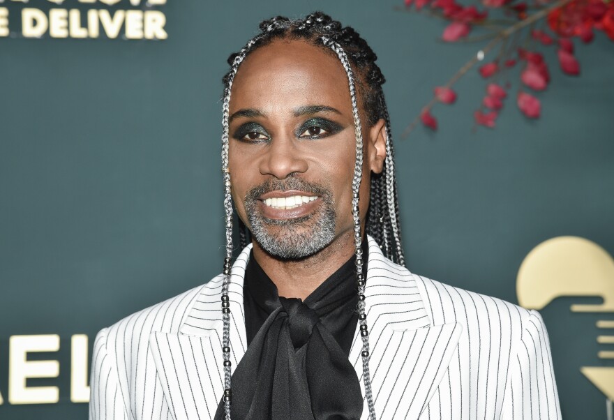 Billy Porter wearing a white suit jacket with pinstripes