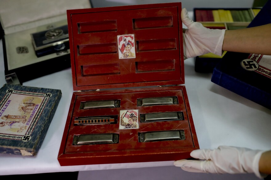 The trove included toys used to indoctrinate children, such as this box marked with swastikas and containing harmonicas.