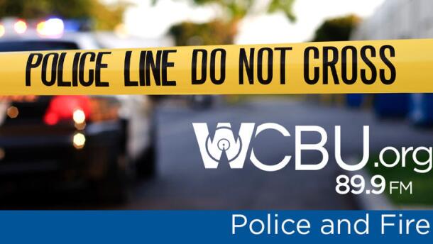 Yellow police tape stretches across a blurry crime scene. It says "Police Line Do Not Cross." The text "WCBU Police and Fire" lays on top of that photo.