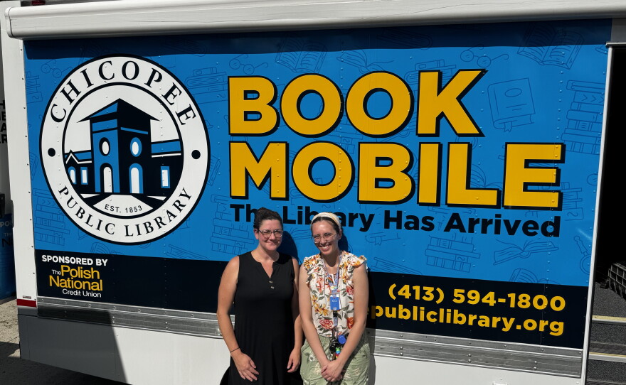 Chicopee librarians Brigitte Lyman and Beth Oliveria with the Chicoppee bookmobile at the Cabot Manor youth center.