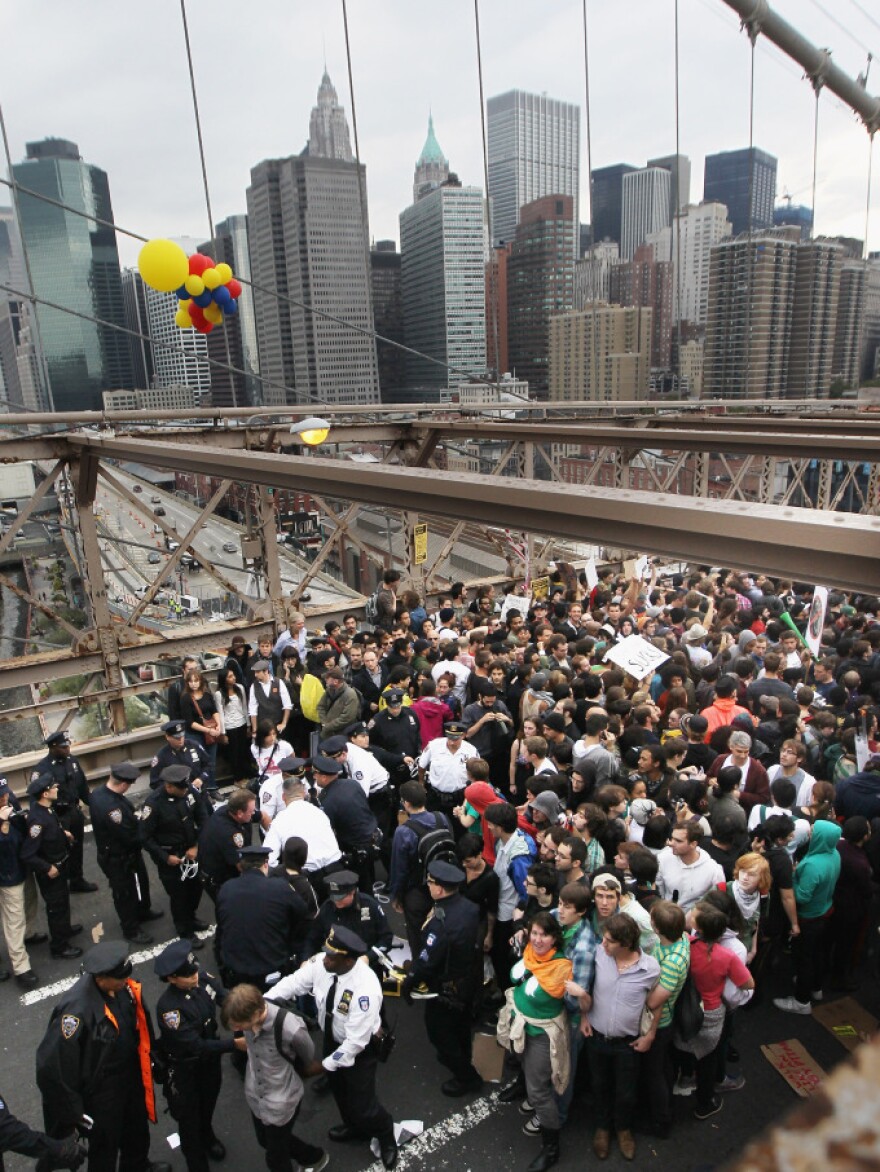 <p>Police arrest two Occupy Wall Street demonstrators after they tried to cross the Brooklyn Bridge on Oct. 1. Media coverage spiked after the incident.</p>