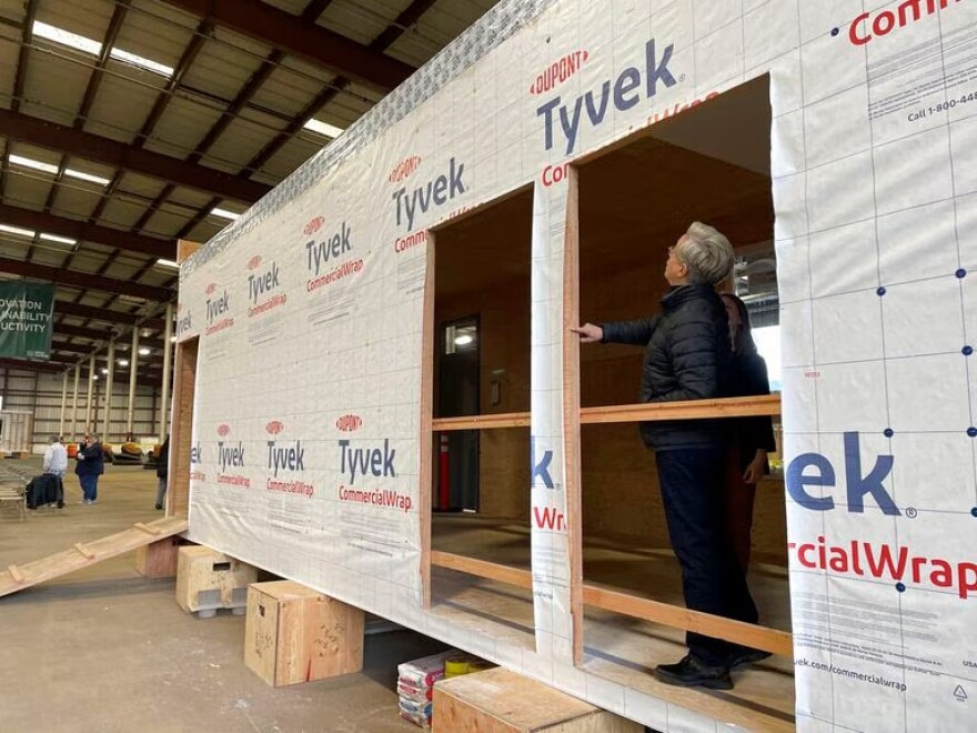 Oregon Gov. Tina Kotek examines a mass timber affordable housing prototype at the Port of Portland in Portland, Ore., Friday Jan. 27, 2023. The Oregon Mass Timber Coalition aims to open a factory at the port that could mass produce homes and potentially alleviate the state's housing shortage.