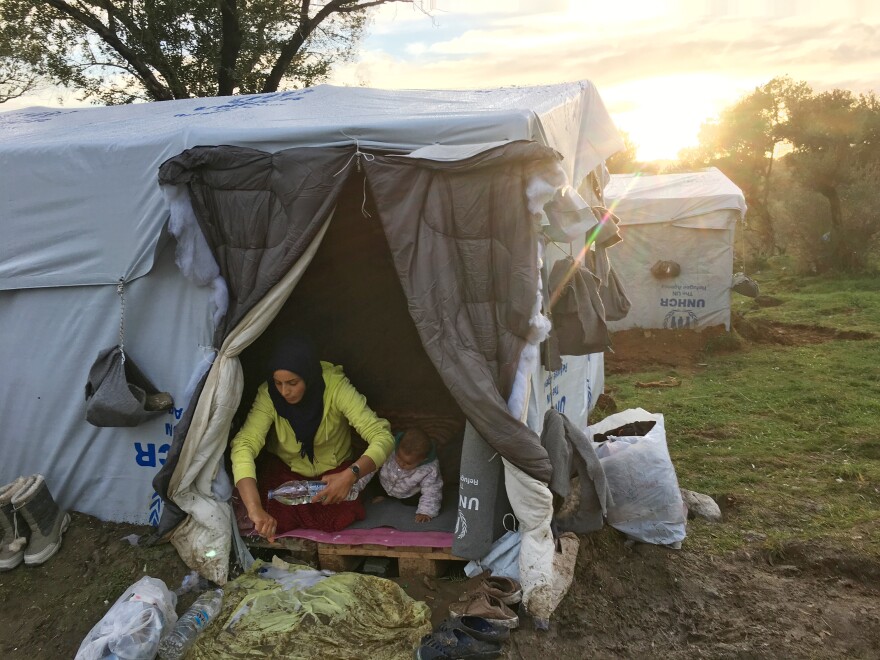 Rasha al-Ahmad, 25, washes her hands with donated bottled water inside a tent her family put up next to the Moria refugee camp. Her 1-year-old daughter, Tamar, is next to her. "The biggest challenge is keeping myself and my children clean," she says.