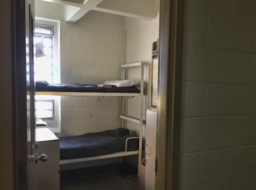 A prison cell at the Idaho Department of Correction with a bunk bed and the door open. 