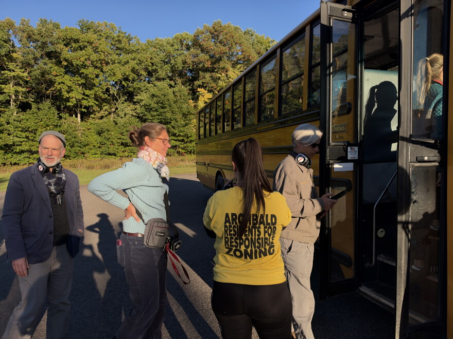 Christian and Melinda Krokus and Jill Baer head onto a bus tour of proposed data center campuses in Archbald. Tamara Misewicz-Healey, cofounder of the Stop Archbald Data Centers group, stands in the yellow shirt.