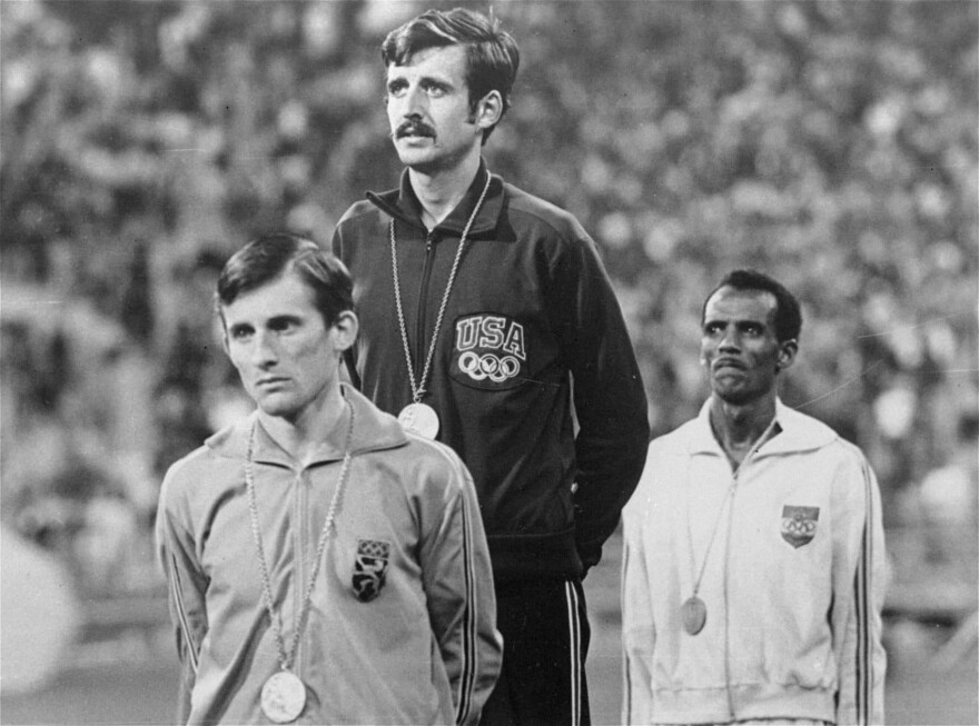 Frank Shorter stands atop the podium during the medal ceremony at the Olympics in Munich Sept. 10, 1972. (AP)
