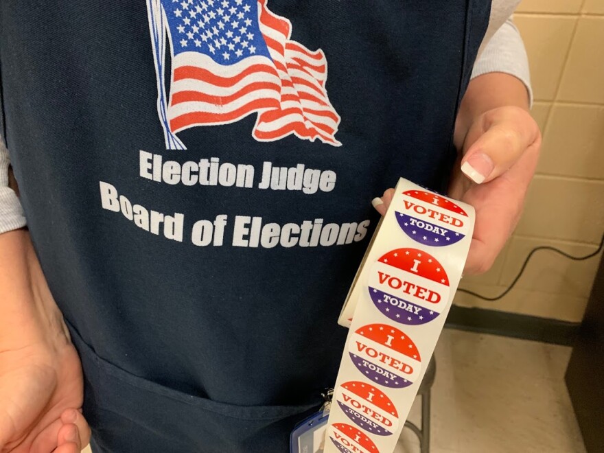 An election judge prepares to hand out "I voted" stickers during the March 2020 primary.