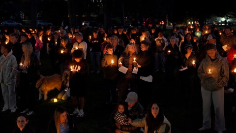 People gather for a candlelight vigil held in Drake Park in Bend, Ore., Oct. 15, 2026, following the shooting at Silver Rail Elementary School earlier in the day.