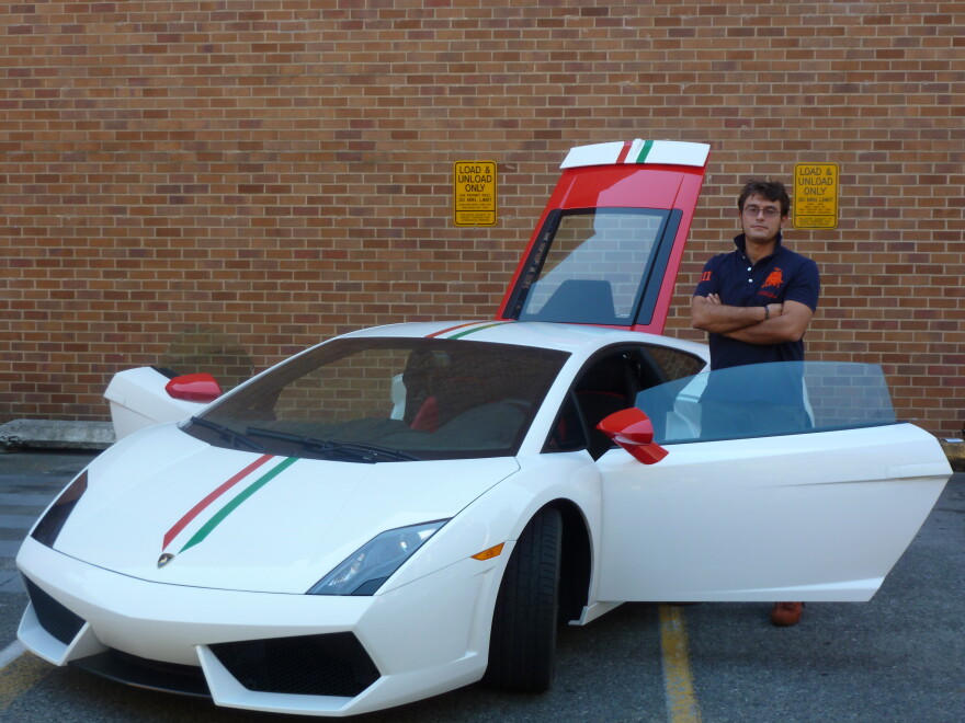 Paolo Feraboli stands next to a carbon fiber Lamborhini the colors of the Italian flag. It was built by his lab at the University of Washington.