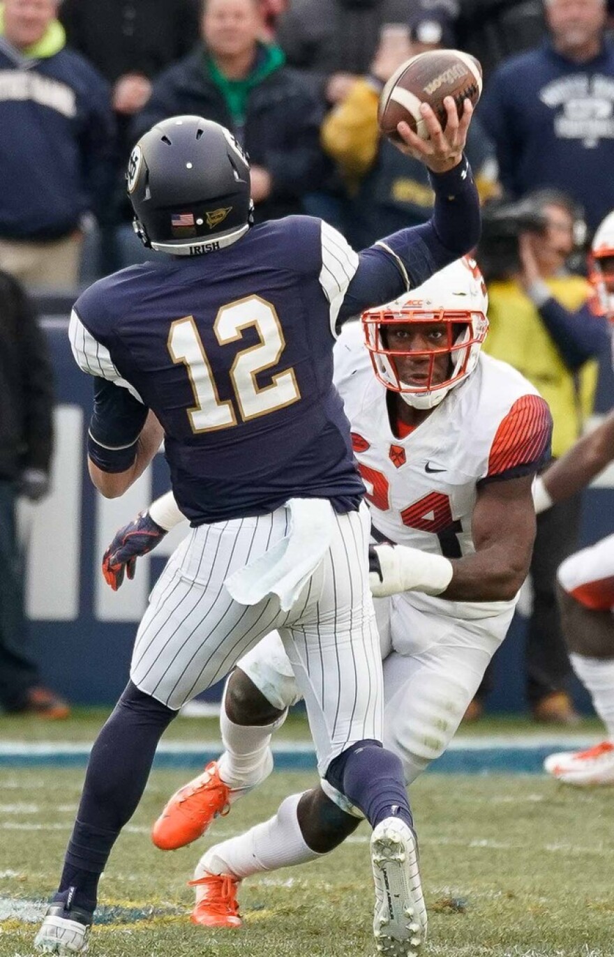 Notre Dame quarterback Ian Book (12) releases a pass under pressure versus Syracuse in 2018. The senior has accounted for 18 total touchdowns and one interception this season.