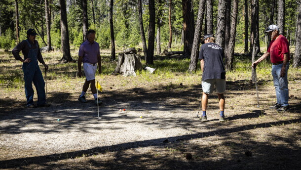 Logan Joyce, one of many members of the Ledford family who played in the 4th of July tournament, putts on one of the Yellow Pine Country Club's signature fine sand greens.