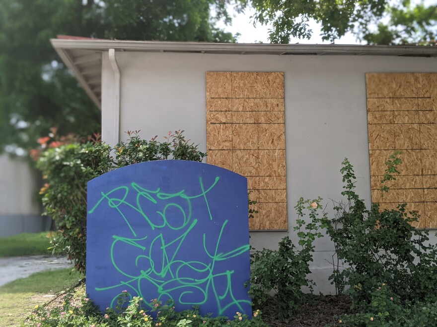 The 503 Urban Loop structure is boarded and graffitied.