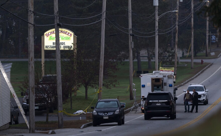 Investigators are outside Schemengees Bar and Grille in the aftermath of a mass shooting in Lewiston, Maine, Friday, Oct. 27, 2023. Shocked and fearful Maine residents are keeping to their homes for a second night as hundreds of police and FBI agents search intently for Robert Card, a U.S. Army reservist authorities say fatally shot several people at a bowling alley and a bar.