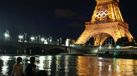 Spectators view the Eiffel Tower and Olympic rings along the Seine river in Paris, France. The city is gearing up to host the XXXIII Olympic Summer Games from July 26 to August 11.