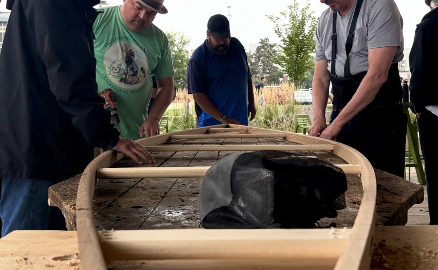 Ron J. Paquin, his apprentices and volunteers building the birch canoe.
